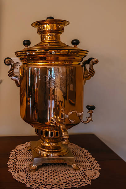 Old vintage copper samovar on wooden table.