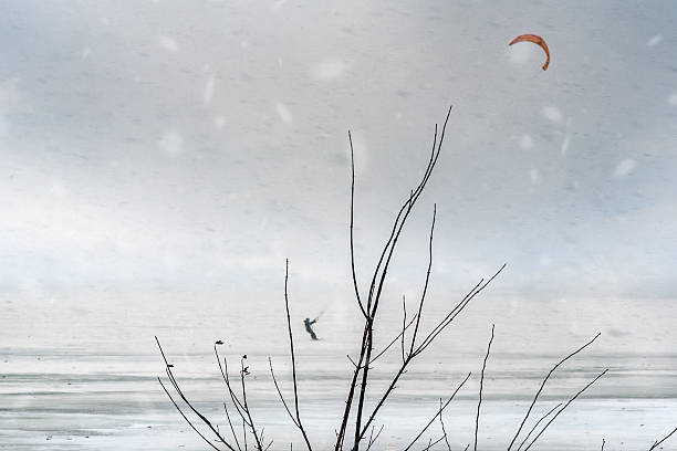 Samara, Russia - February 12, 2025: Snowkiting kitesurfing on the ice of a frozen river.