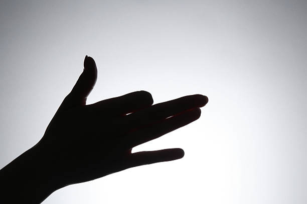 Shadow puppet. Woman making hand gesture like dog on light background, closeup. Space for text