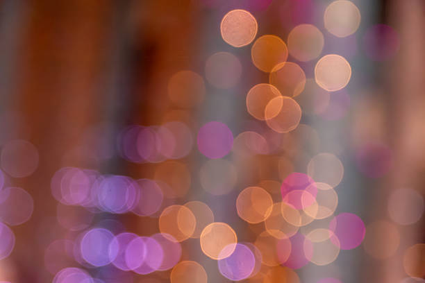 Soft colorful circles from out-of-focus bulbs give warm festive vibe, perfect to use as background for your messages or social posts with unfocus