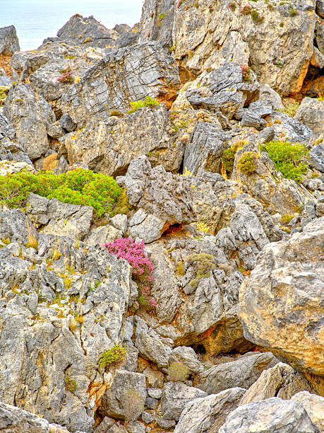Crete landscape in Greece showcases rugged mountains, rocky hills, and an arid hillside beneath a bright blue sky with white clouds. This natural outdoor scene highlights Greek terrain and scenery, perfect for travel, nature, tourism, and adventure stock projects celebrating Crete and Greece.