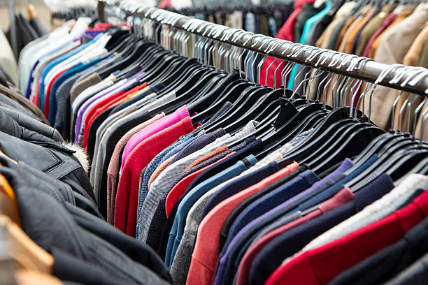istock Used clothes hanging on a rack at a flea market 2258786987