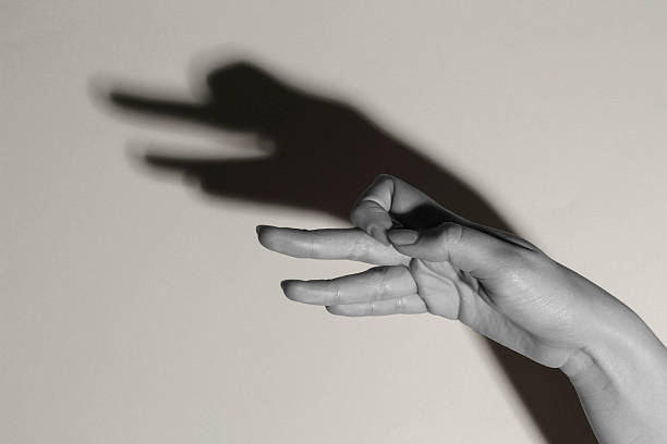 istock Shadow puppet. Woman making hand gesture like goose on light background, closeup with space for text. Black and white effect 2258788577