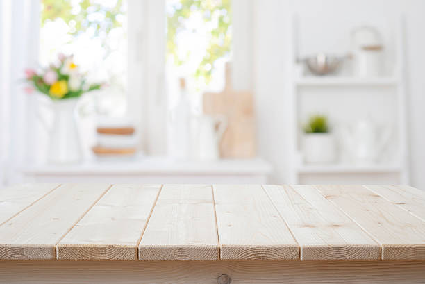 istock Wooden planks table with deeply blurred view on kitchen window interior as background 2258797989