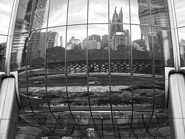 Reflections on the glass facade of Henderson skyscraper in Hong Kong Central district, a new iconic 190 mt tall skyscraper designed by Zaha Hadid Architects. The tower's exterior is inspired by a blossoming bauhinia, the flower that has appeared on Hong Kong's flag since Britain handed control of the territory back to China in 1997.