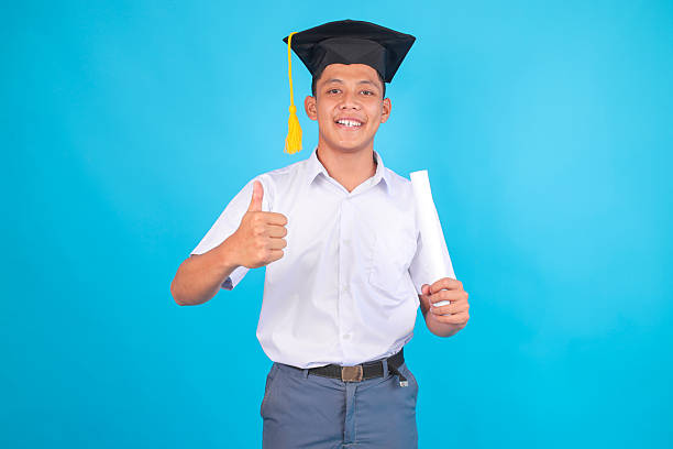Young Man in Graduation Cap Giving Thumbs up With Diploma