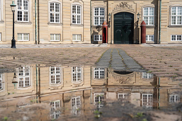 Amalienborg Slotsplads Copenhagen with the sourrounding official residence for the Danish royal family . Captured at sunset during summer season.
