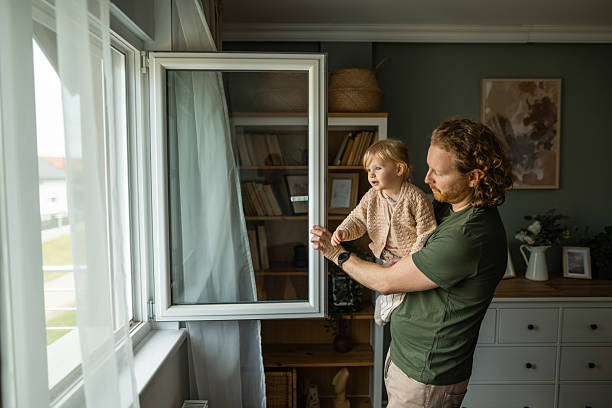 Father and daughter enjoying time together looking out a window