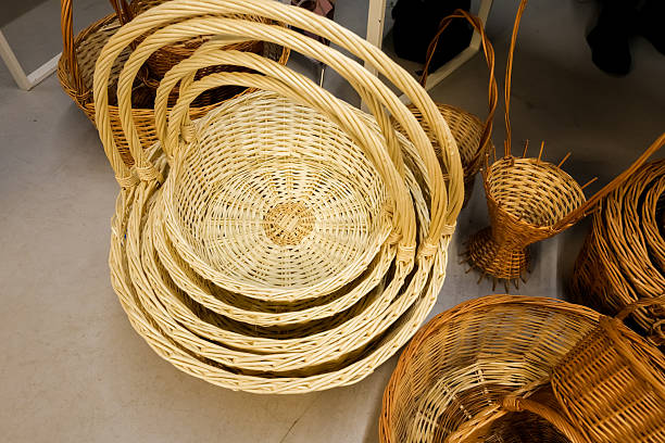 Assortment of woven baskets in various sizes and shades made from natural wicker and rattan, showcasing traditional weaving techniques and eco-friendly craftsmanship.