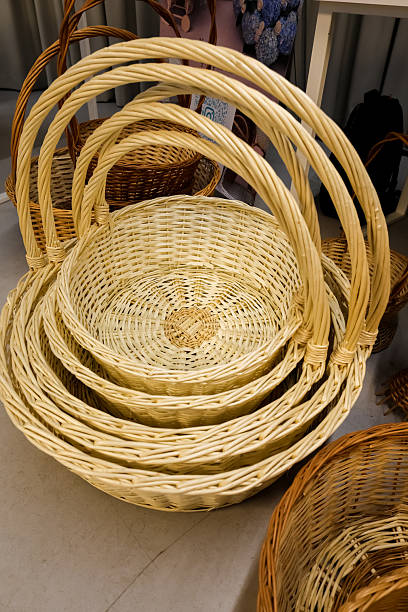 A woven basket filled with curling white ribbons sits in a venue, prepared for a special occasion like a wedding or celebration.