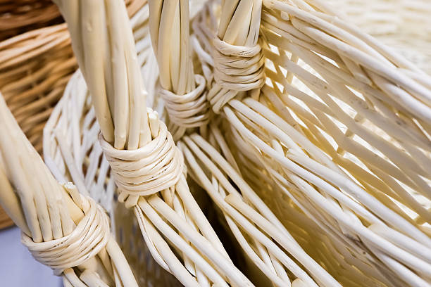 Assortment of woven baskets in various sizes and shades made from natural wicker and rattan, showcasing traditional weaving techniques and eco-friendly craftsmanship.