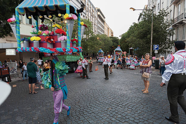 Lisbon, Portugal - June 12, 2022: A man dressed in traditional folklore costume, crries a giant prop while heading to parade in Lisbon downtown during this city celebrations of the Popular Saints.