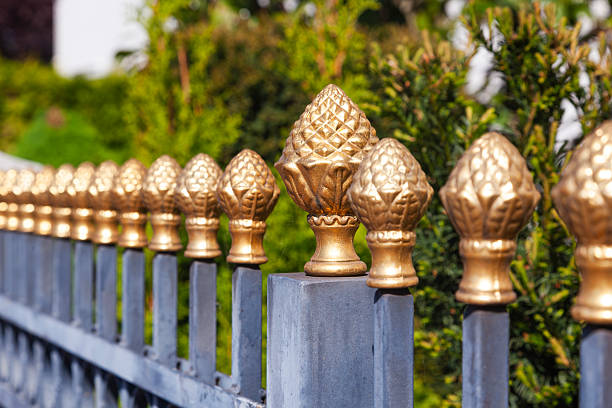 Steel fence with decorative bronze tips on it.