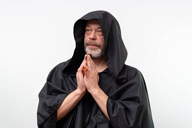Old man with a beard praying