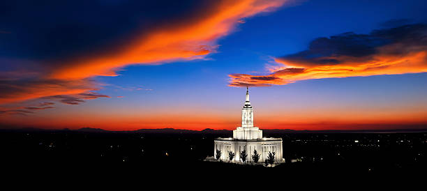 Pocatello Idaho LDS Mormon Latter Day Saint Temple at sunset with glowing lights and trees