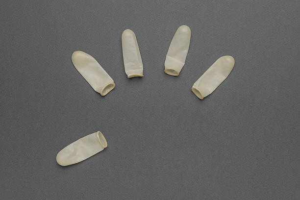 Protective Latex Finger Cots Arranged on Gray Background for Medical Use