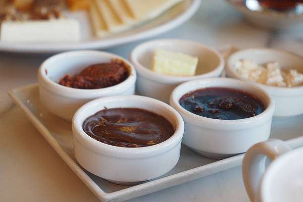 Different spreads displayed in small bowls on a serving platter.