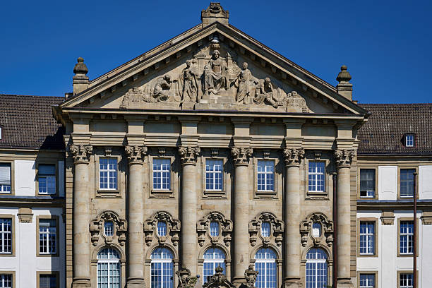 Detailed view of the neo-baroque facade and pediment of the Higher Regional Court (Oberlandesgericht) in Cologne, Germany. Built in the early 1900s.