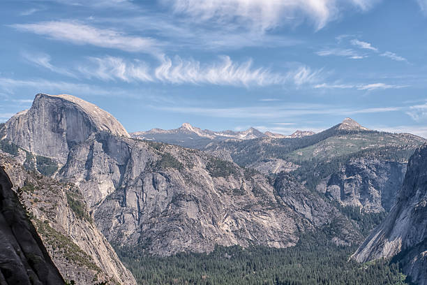 The mountains are covered in snow and the sky is clear. The view is breathtaking and serene
