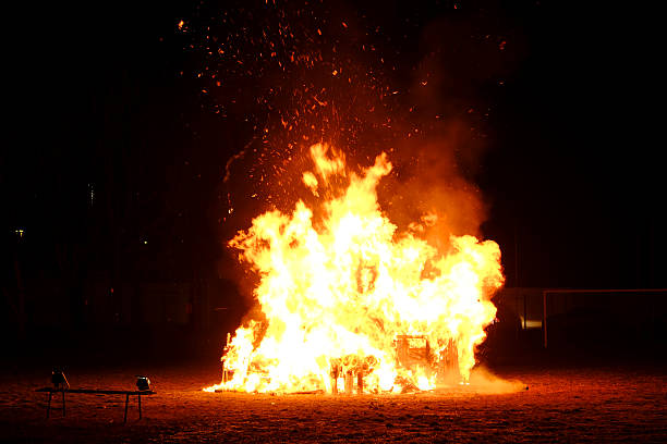 Burning cars, unrest, anti-government, crime. Consequences of the collision. Car on fire isolated on black background. Attempt to extinguish a fire by a fire extinguisher