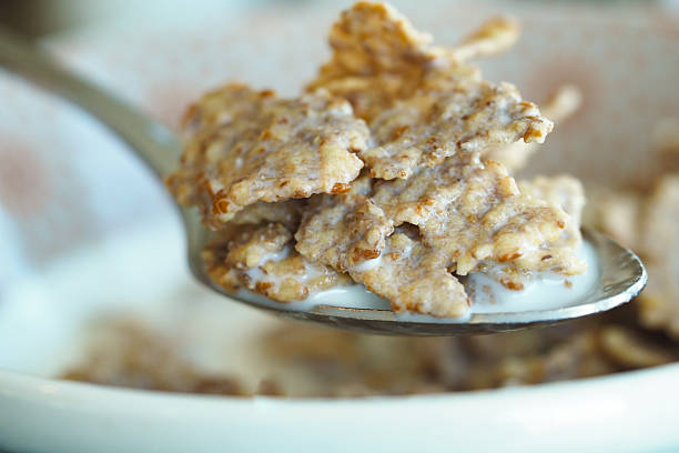 A close-up view of crunchy cereal with milk on a spoon, ready to be enjoyed.