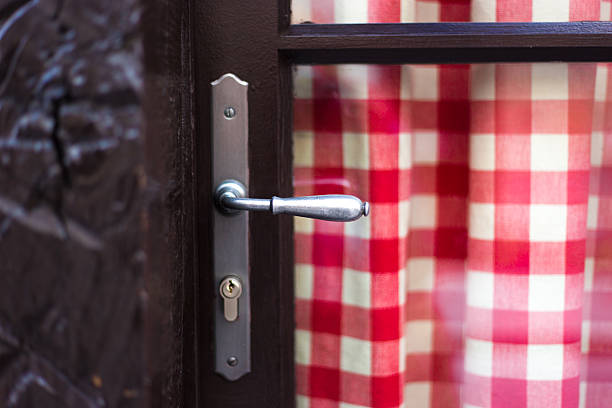 France: Old-Fashioned Red Checked Curtain on Vintage Door