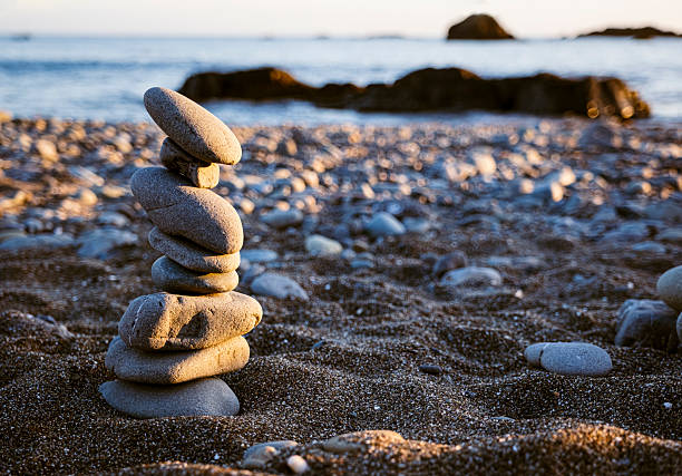 A cairn built on the rocky beach at Crescent City, California near sunset.