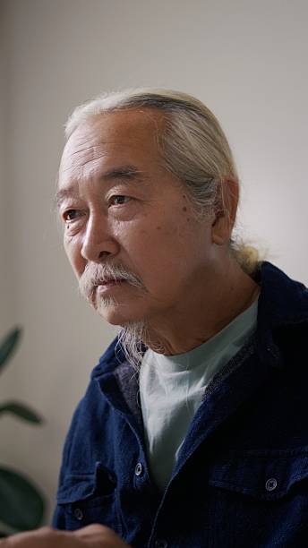 istock Focused 70+ Asian Male Attending Online AI Course at Home Office Workspace. 2258974640