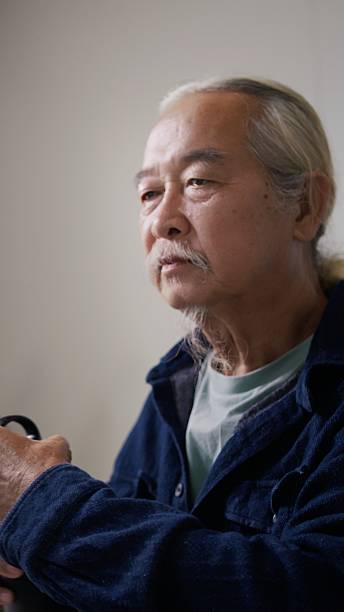 Asian Senior Man 70+ Learning AI at Home Office with Aluminum Water Bottle for Eco-Friendly Wellness.
