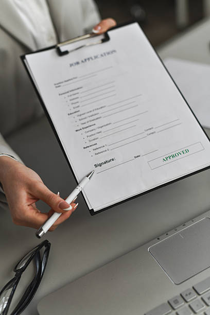 HR or manager hand pointing at the signature line on a document, candidate hand ready to sign, emphasizing professionalism and clarity.