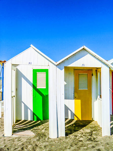 Colorful beachhouses and dressingrooms along the shore in the afternoon sun at the beaches of Santa Margherita Ligure next to Portofino on the italian riviera south of Genoa - Italy