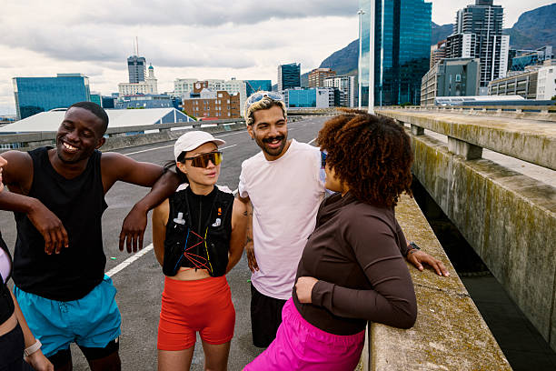 Diverse group of friends smiling, enjoying a social gathering after a morning run