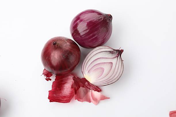 Red onions and peels isolated on white, top view
