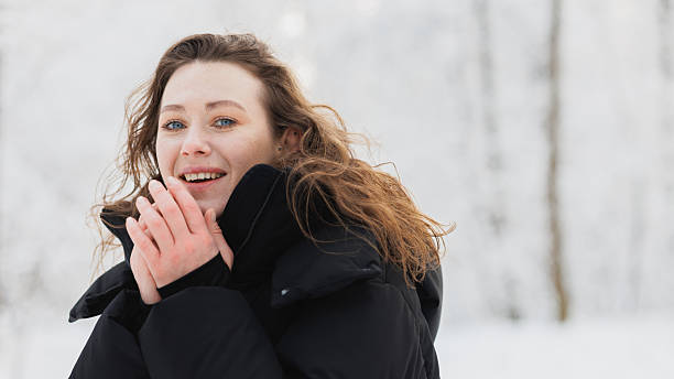 A portrait of happy little girl in winter forest