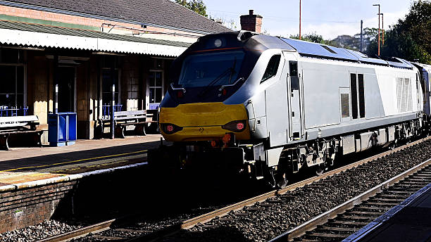 A station England UK. Diesel powered railway line in the English countryside. Station on a sunny day. Panoramic - Panorama.