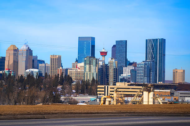 Calgary, Alberta, Canada. Jan 30, 2026. Panoramic view of the downtown Calgary skyline featuring the Calgary Tower and office skyscrapers under a clear blue sky.