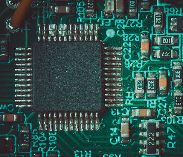 Detailed macro view of integrated circuit on printed circuit board, modern electronic technology concept.