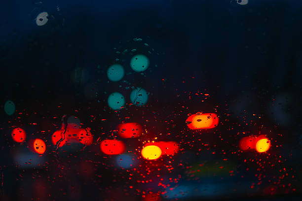 Rain droplets on a transparent surface with blue cold tint.