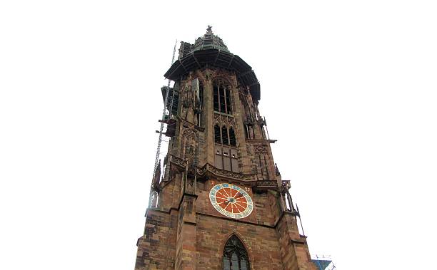 Detailed view of the clock tower of Freiburg Minster Cathedral in Freiburg im Breisgau, Germany, built of red sandstone between 1200 and 1530, with parts under restoration and visible scaffolding, DE, 27 Feb. 2011