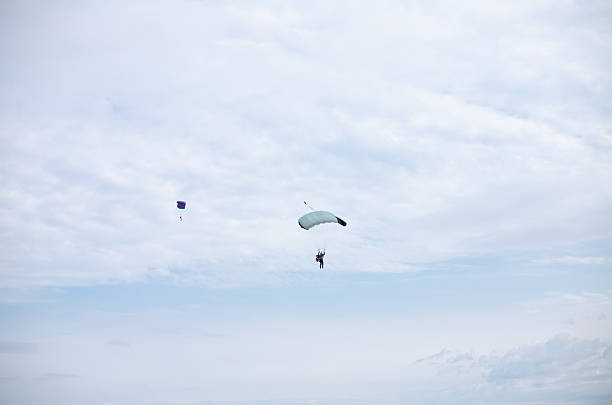 Orange, Virginia, USA - August 11, 2024: A sky diver descends over the landing zone at “Sky Dive Orange” at the Orange County Airport on a sunny summer afternoon.
