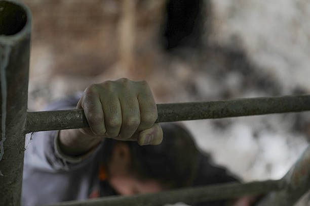 Close Up Of Worker’s Hand Firmly Gripping Metal Railing In Industrial Basement, Concept Of Physical Strain, Workplace Fatigue And Manual Labor In Technical Environment.