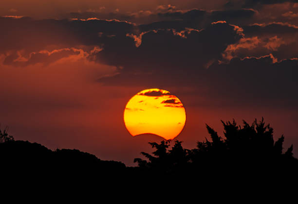 Spectacular partial solar eclipse at sunset in Spain. The moon partially obscures the sun at sunset. Tordesillas, Valladolid, Castile and León, Spain, Europe - August 21, 2017.