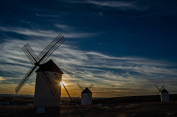 Several windmills at sunset in Campo de Criptana. Colorful sunset with the windmills outdoors. Campo de Criptana, Ciudad Real, Castilla-La Mancha, Spain - September 10, 2017.