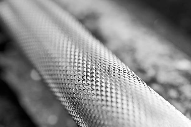 Textured metal surface with a knurled pattern and repeating grid. Clean, abstract industrial detail suitable for background, technology, or design projects.