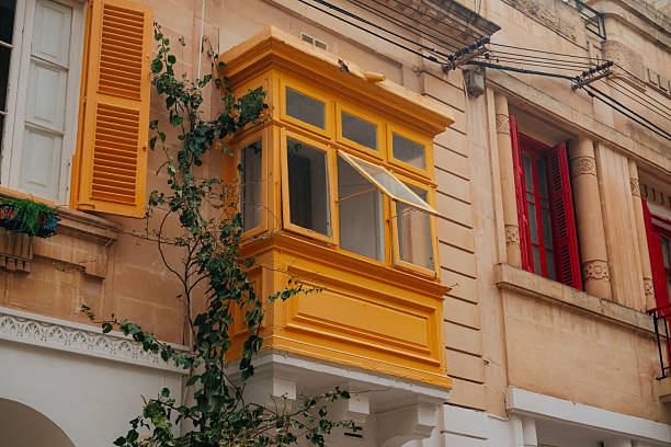 Close-up of yellow traditional wooden balconies in Malta
