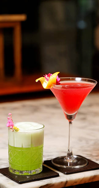 Craft cocktails sitting on marble bar counter in luxury lounge