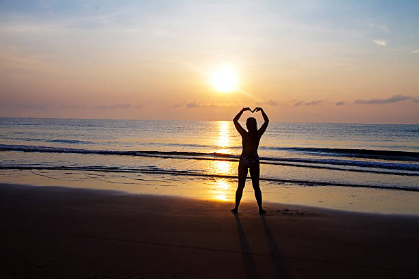 Sunrise and silhouette traveler on beach at beach Bang Boet, Prachuap Khiri Khan Province in Thailand is famous for travel and relax.