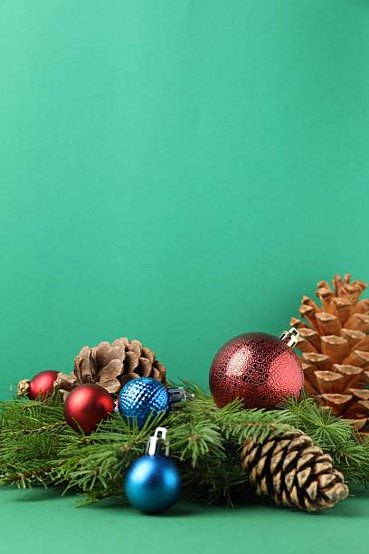 Christmas wooden background with Christmas tree, pinecones and toy. Minimalism. Mockup. Copy space.