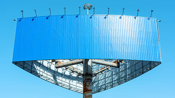 Empty billboard for outdoor advertising against a sunny blue sky