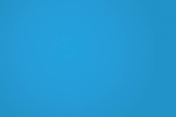 A bright blue background features a smooth, even texture, perfect for design work or creative projects.